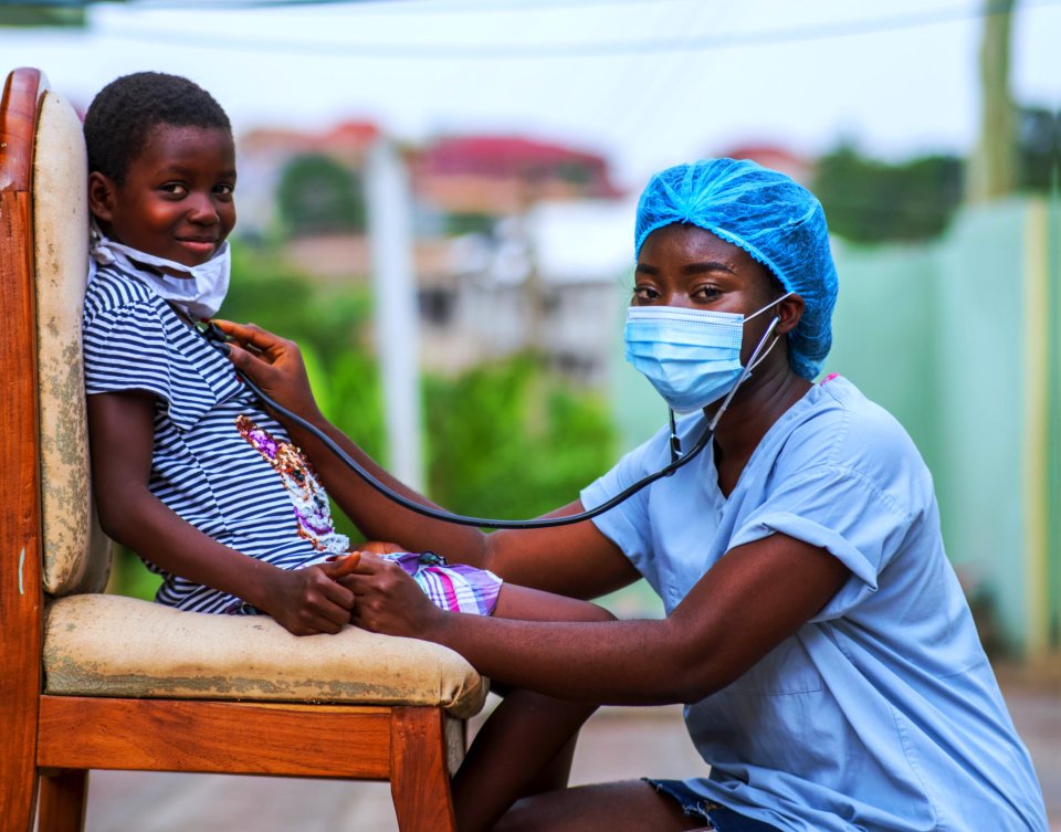 nurse checking the child with her stethoscope