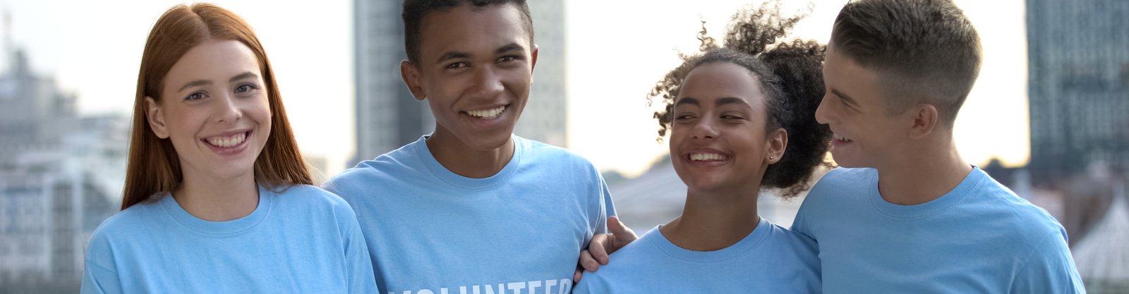 smiling group of people in volunteer t-shirt